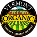 Vermont Certified Organic Logo - Black circle with white serif type and illustration of a crop field