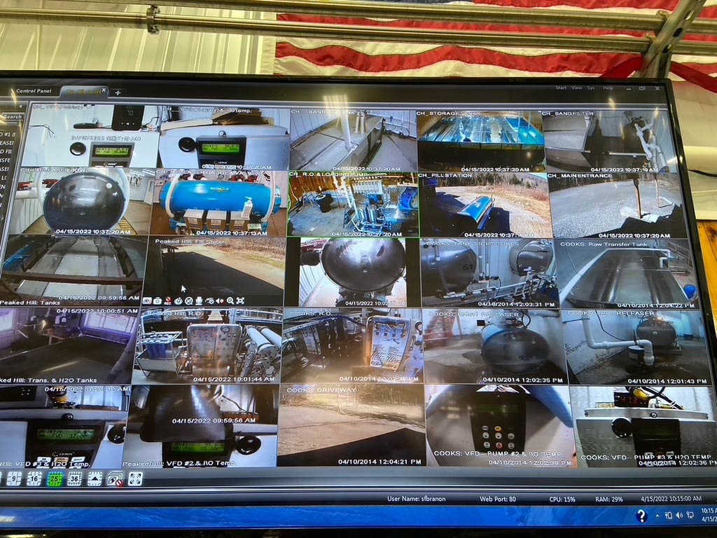 A photo of a video screen showing camera images from the woods