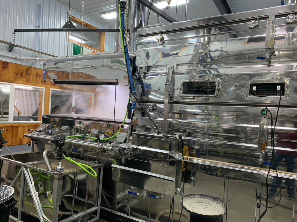 Steam rises from a polished silver evaporator