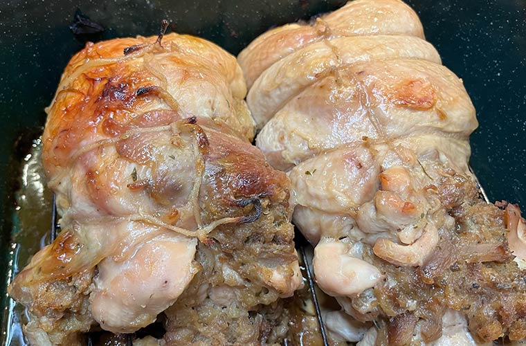 Photo of two stuffed Vermont turkey breasts with pure maple glaze in oven