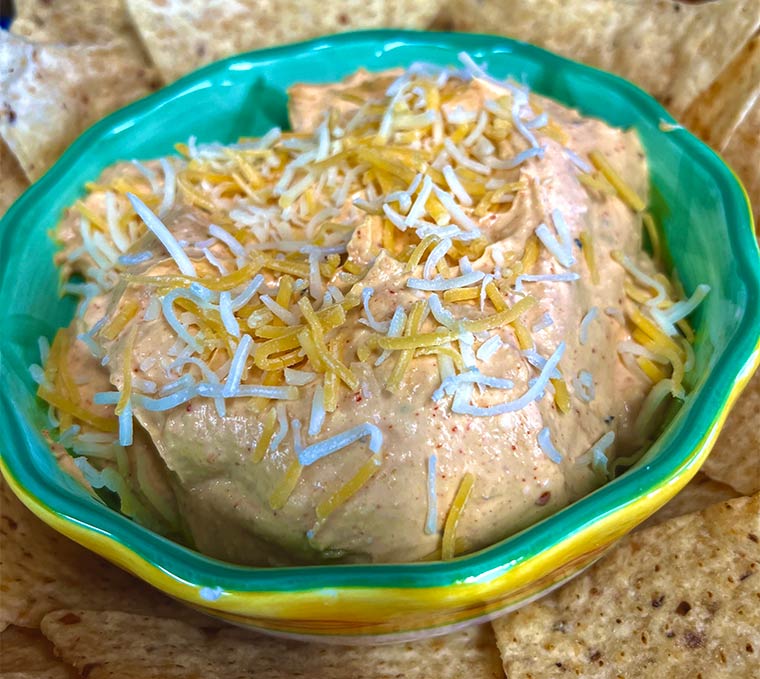 Photo of Maple Buffalo Chipotle Dip in a bowl with tortilla chips surrounding